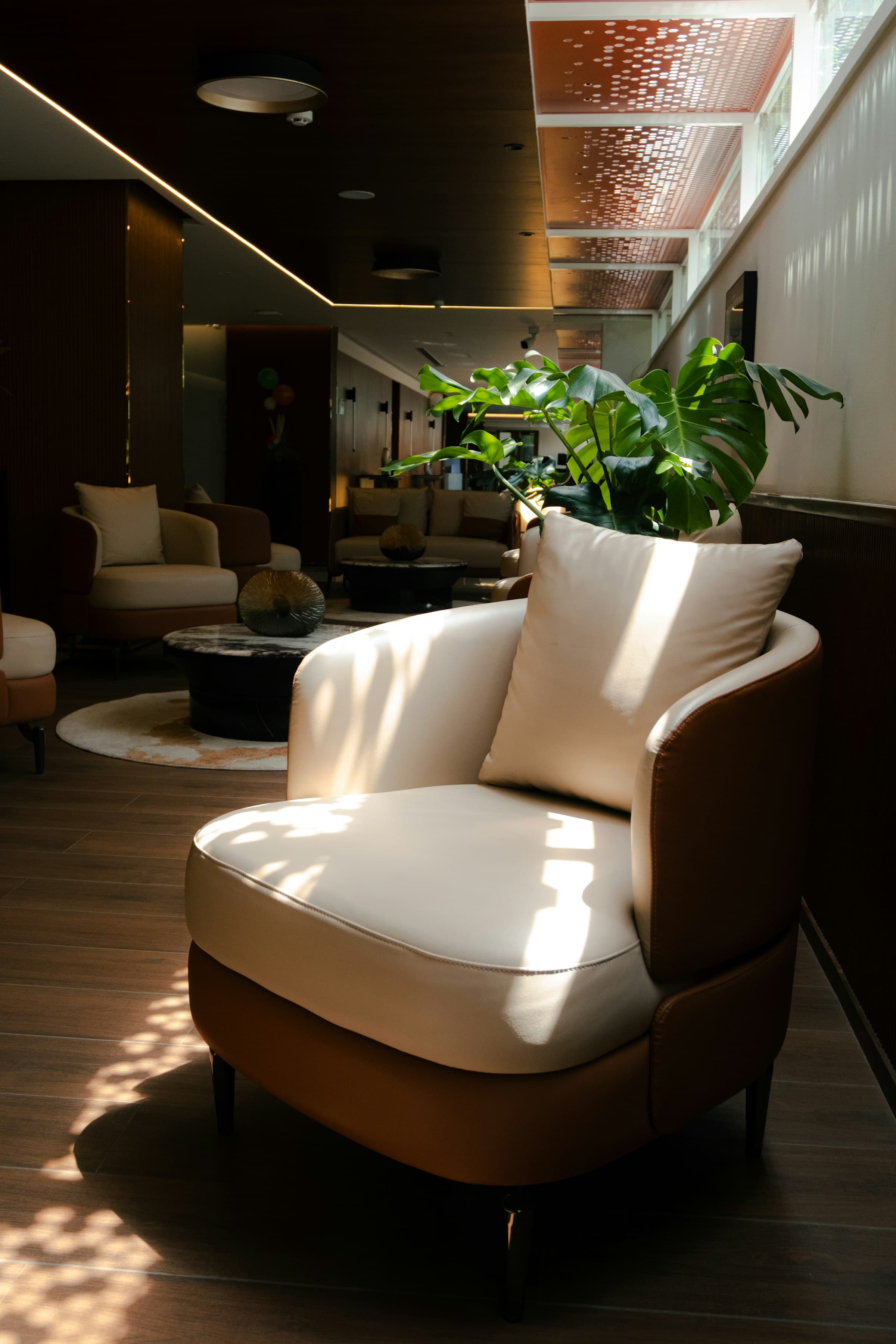 Cream armchair with tan leather sides