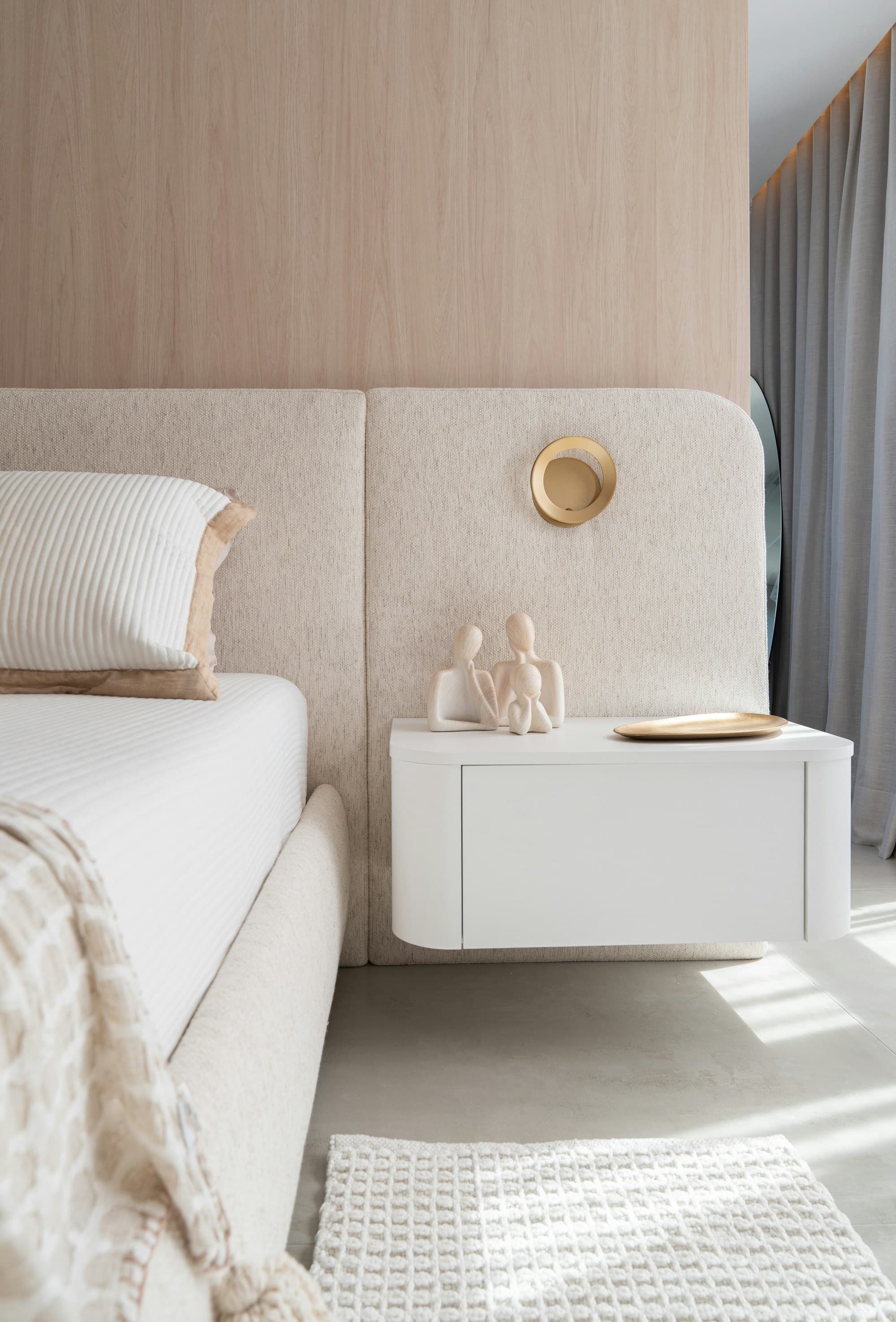 Upholstered headboard with a floating bedside table
