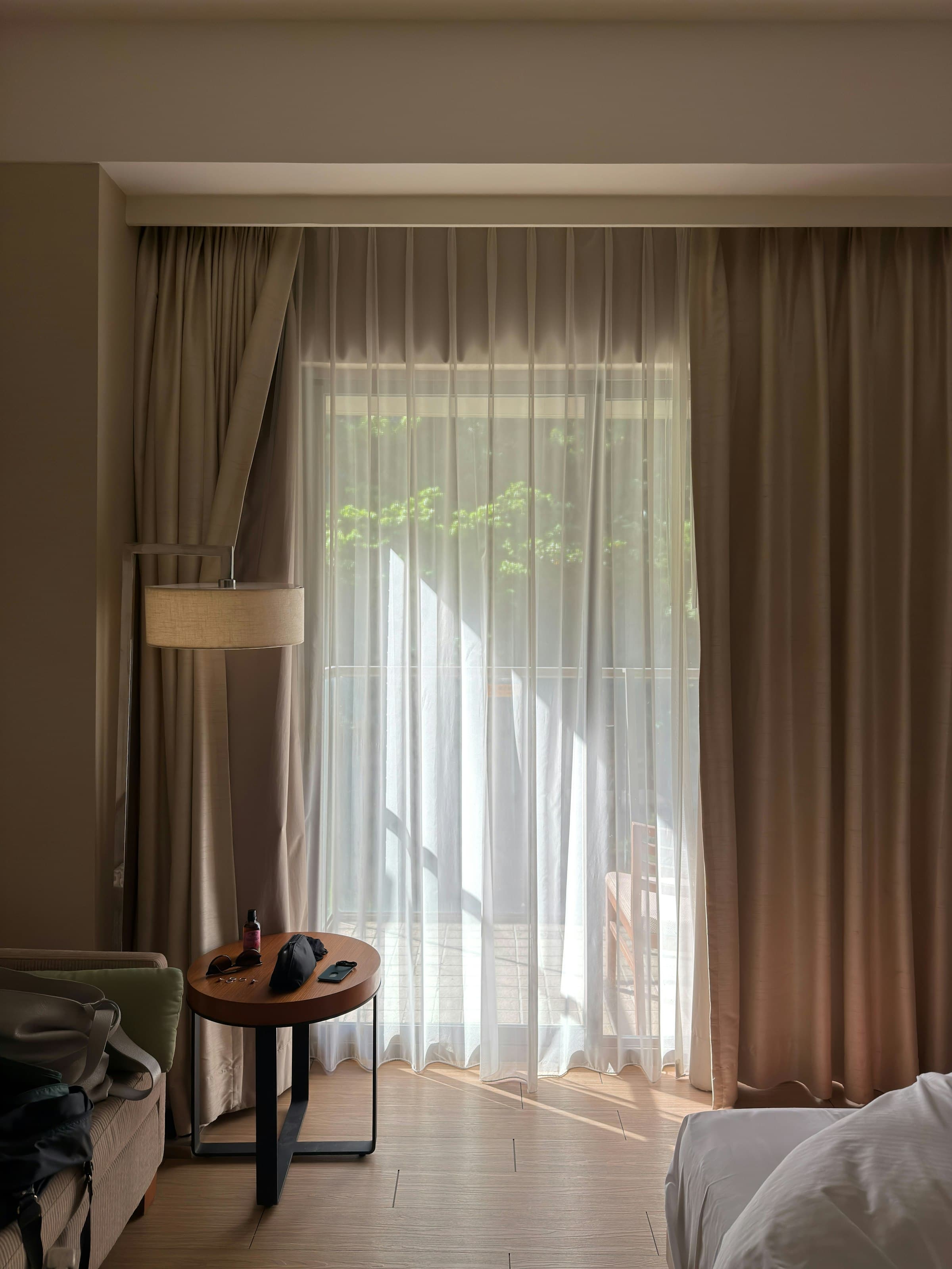 Floor-length drapes framing white sheers