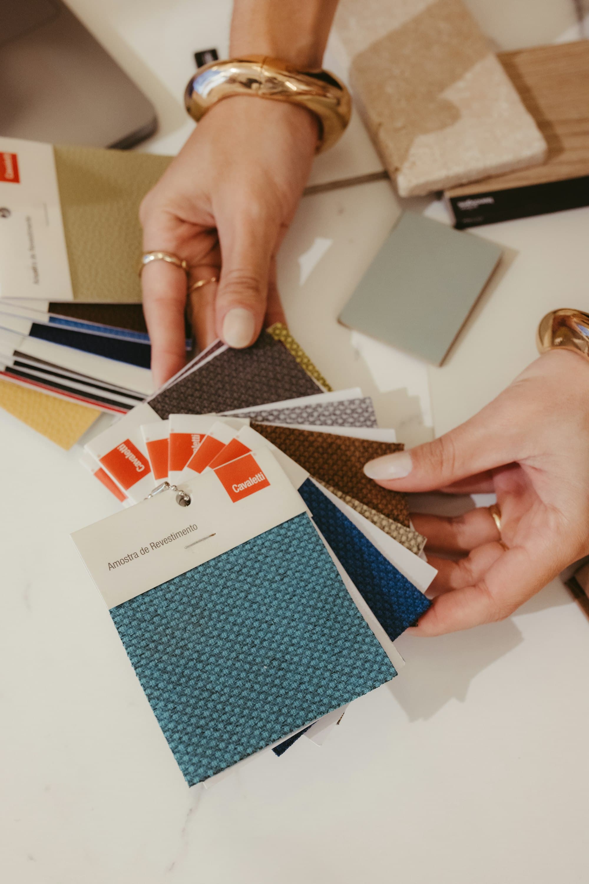 Hands choosing between fabric and colour samples